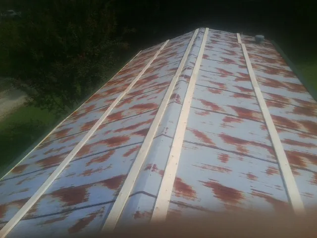 Rusted metal roof panels with new wood purlins before replacement — Storm Damage Roof Repair in Bayonne by Roofing Brothers