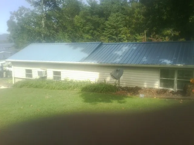 Blue metal roof running the length of a single story home in Bayonne