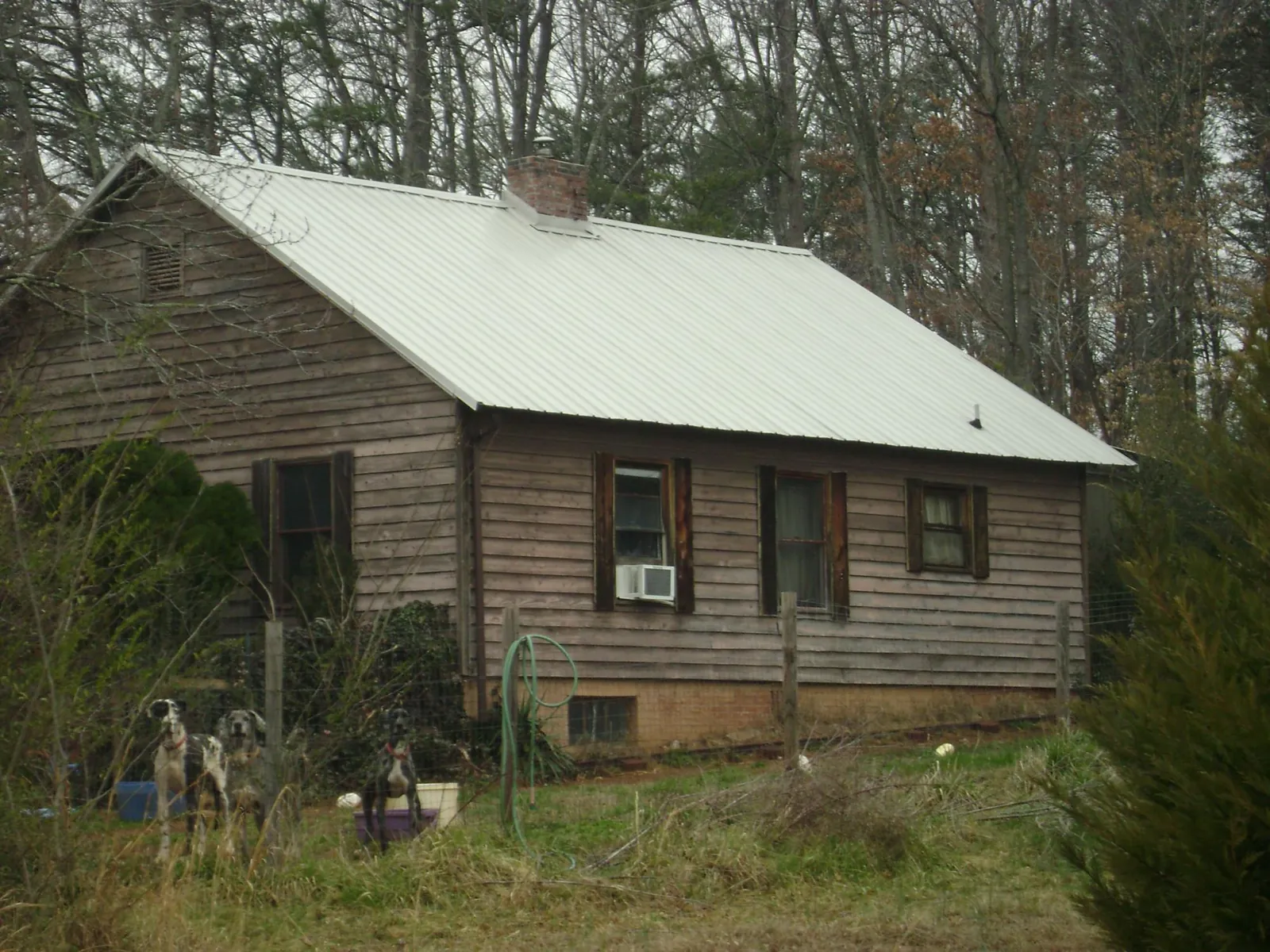 White metal roof on an old wood sided farmhouse, from a Metal Roof Installation job in Bayonne